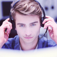 young smiling male call centre operator doing his job with a headset